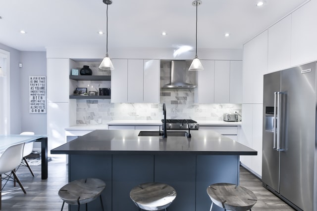 White kitchen with many reflective surfaces