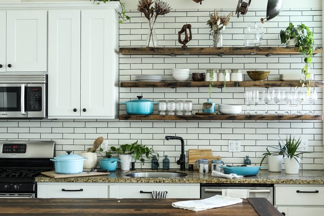 Open shelves in a kitchen with subway tiles